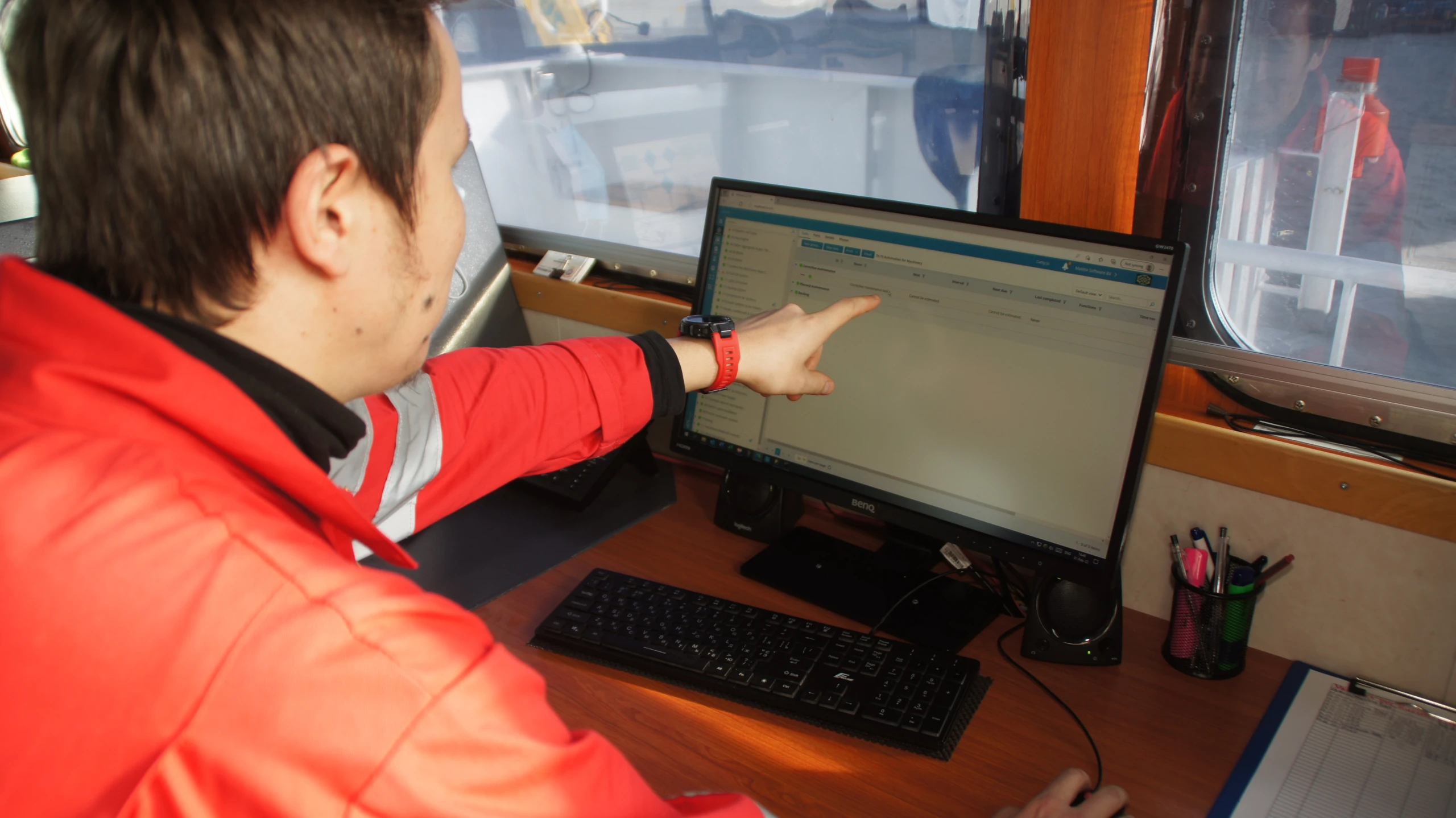 20250219_122628 Crew member reviewing a procurement workflow in MXSuite on board a vessel.